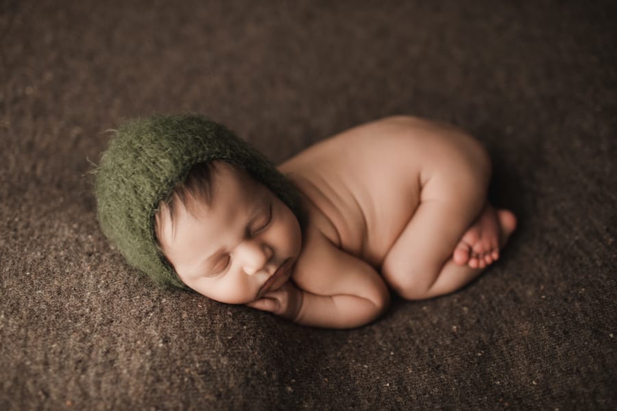 newborn boy in green hat