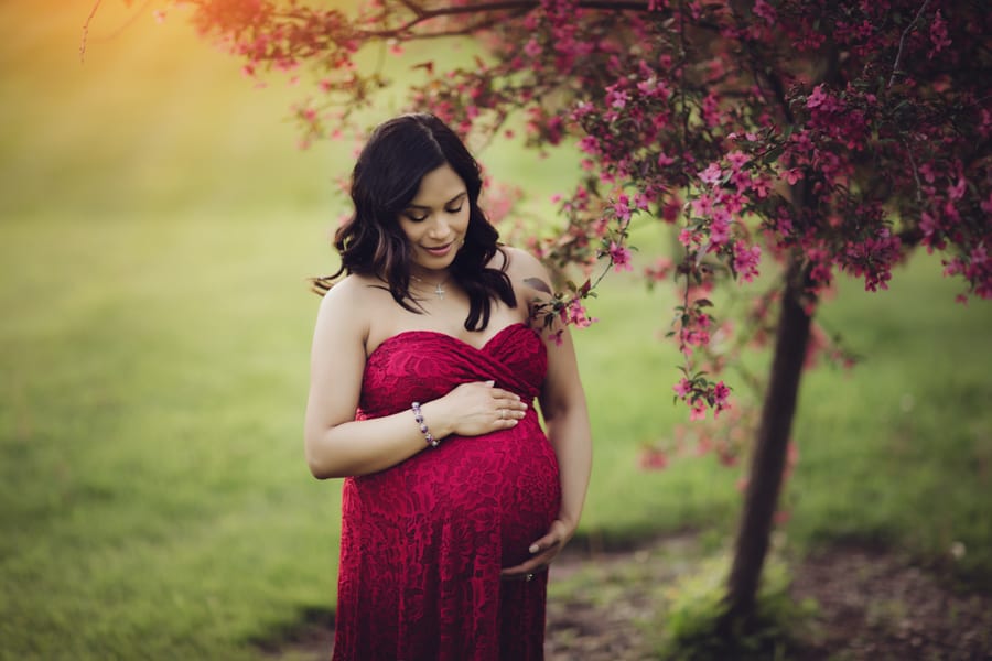 pregnant mom outside wearing maternity gown 