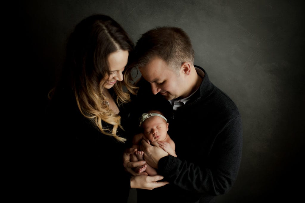 family with their newborn at Palatine newborn photography studio 