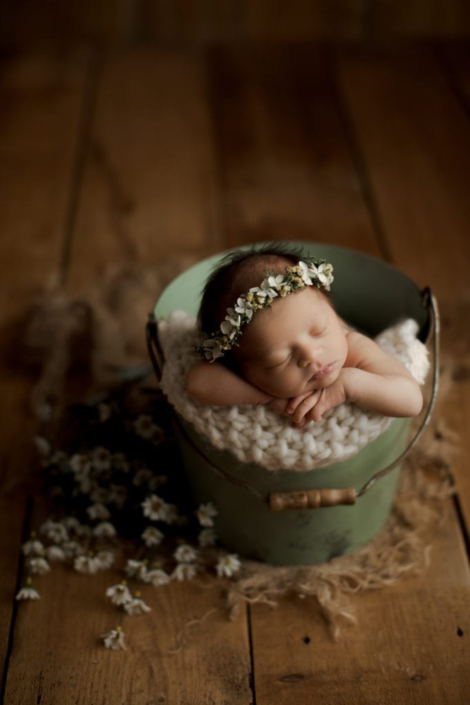 baby girl in green bucket