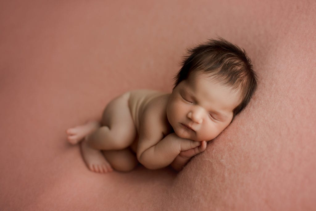 sleeping newborn pink blanket