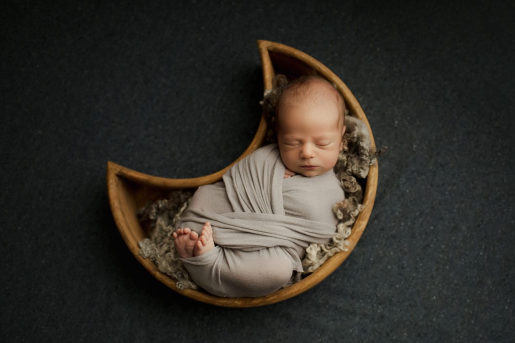 newborn boy in moon basket