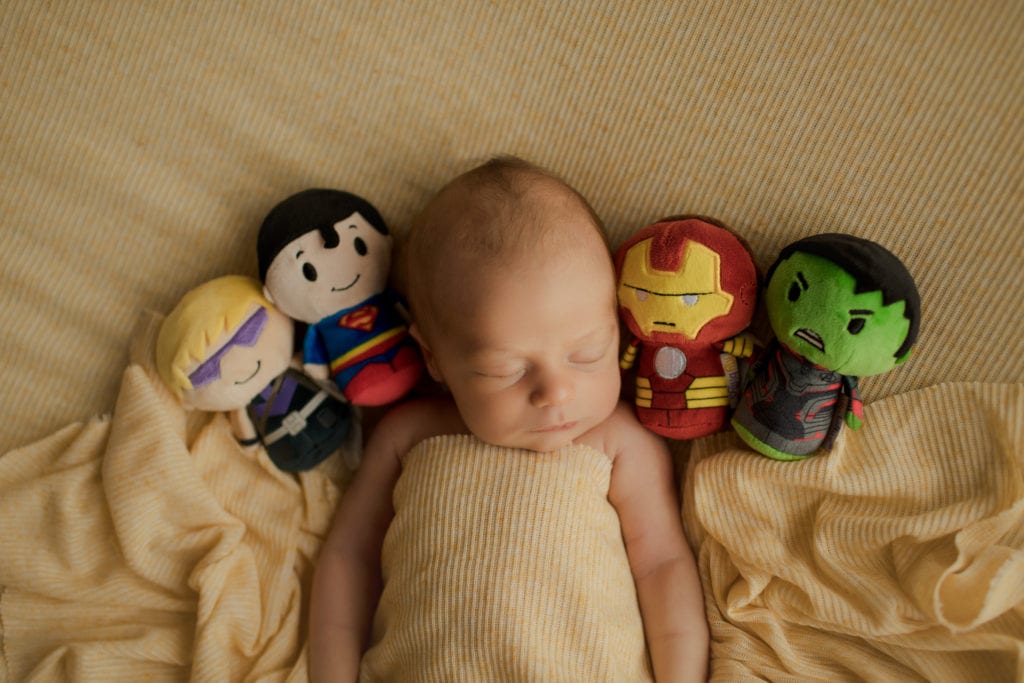 baby boy with superhero stuffed animals