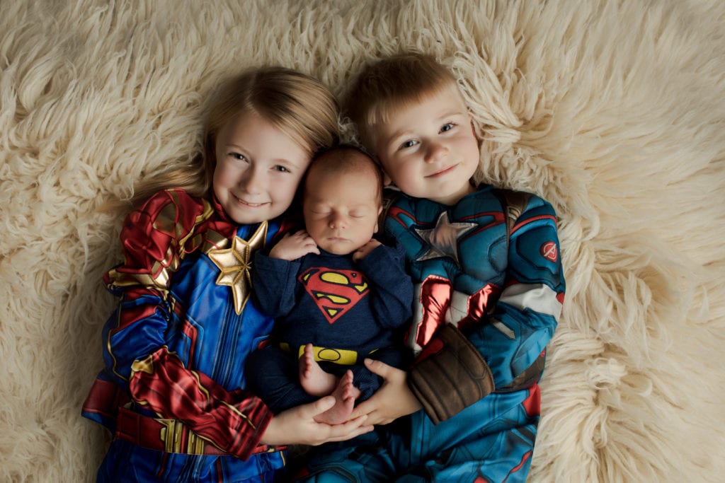siblings in superhero wear