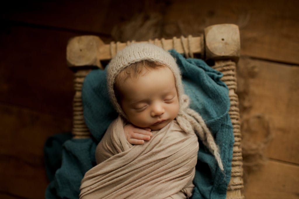 baby boy in little newborn bed