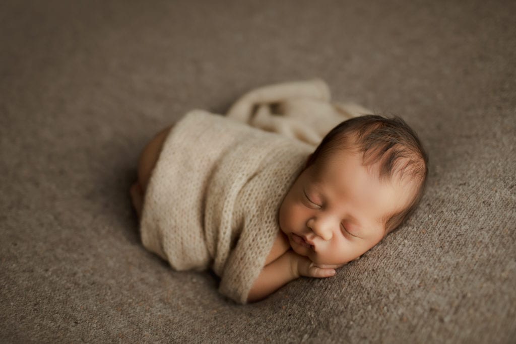 newborn baby boy on brown tones on blanket
