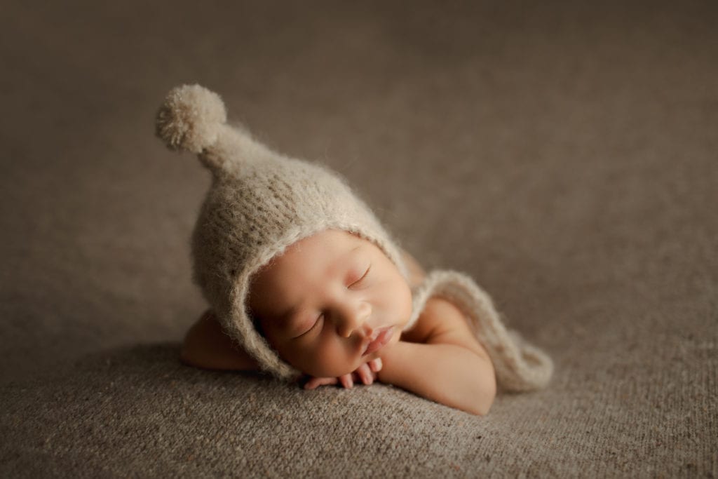 newborn boy in a fuzzy hat