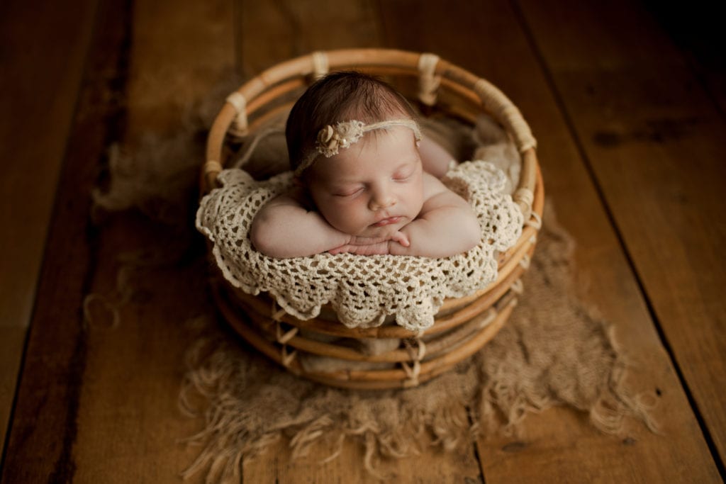 newborn baby girl in a basket