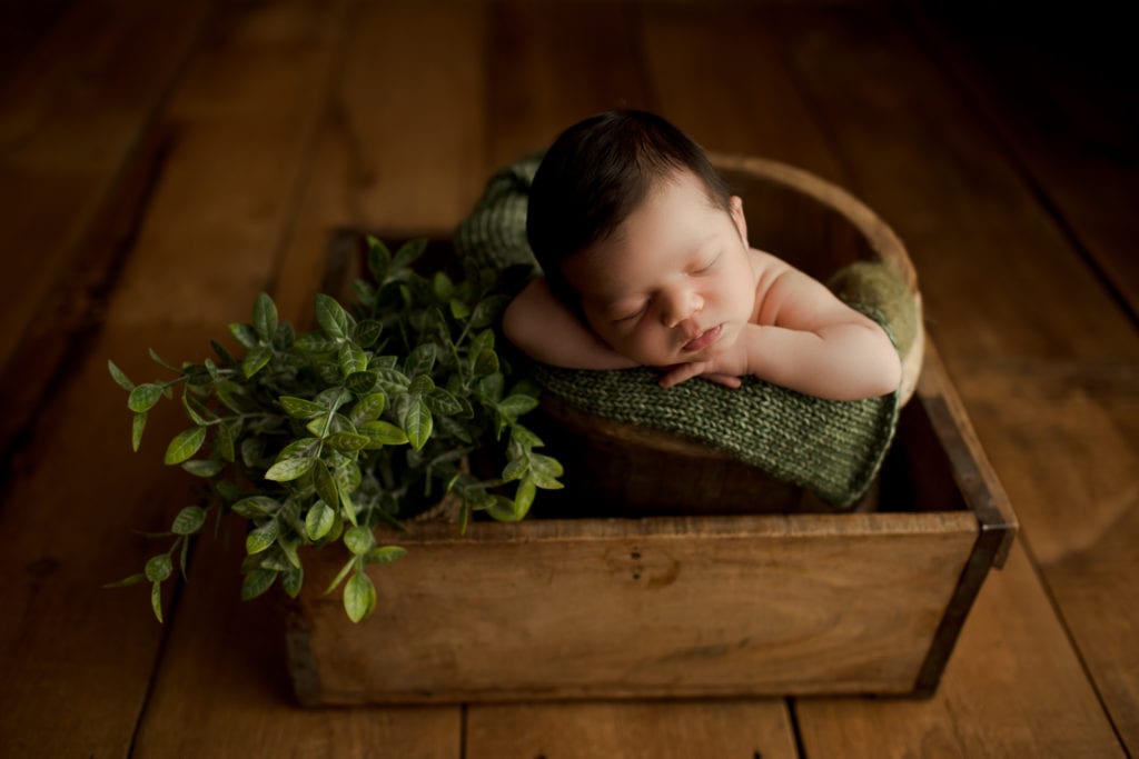 newborn boy in a basket