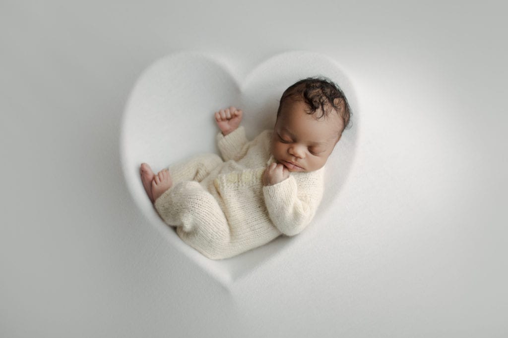 baby in heart shaped bowl