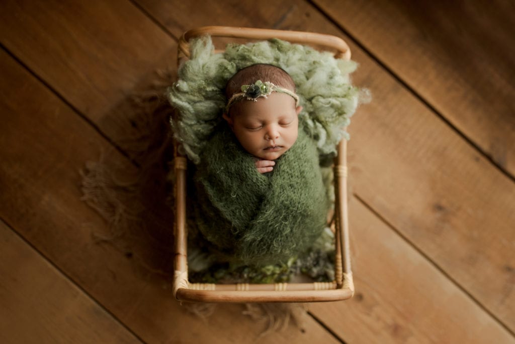 swaddled baby girl in newborn photo shoot