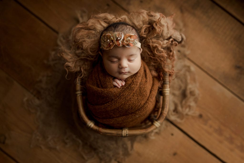 baby wrapped in fall colors