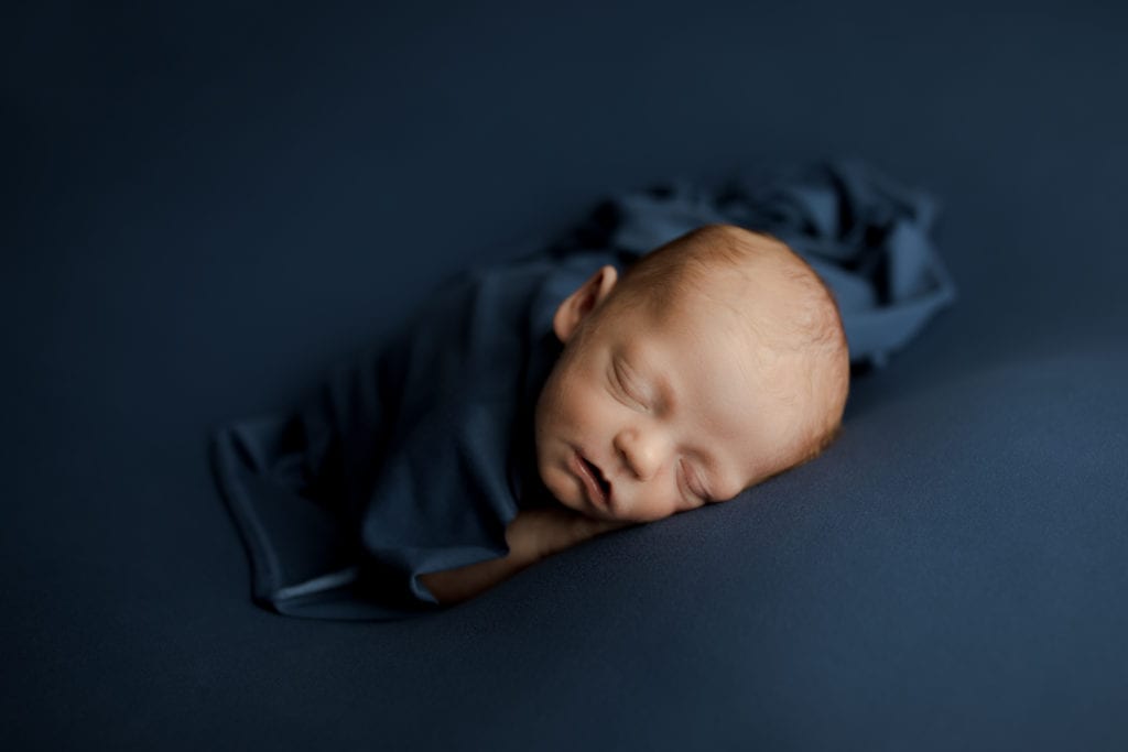newborn baby boy in blues in Long Grove newborn studio