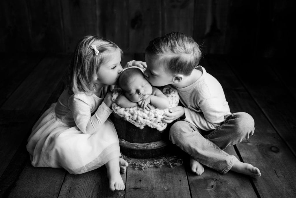 black and white sibling newborn photo