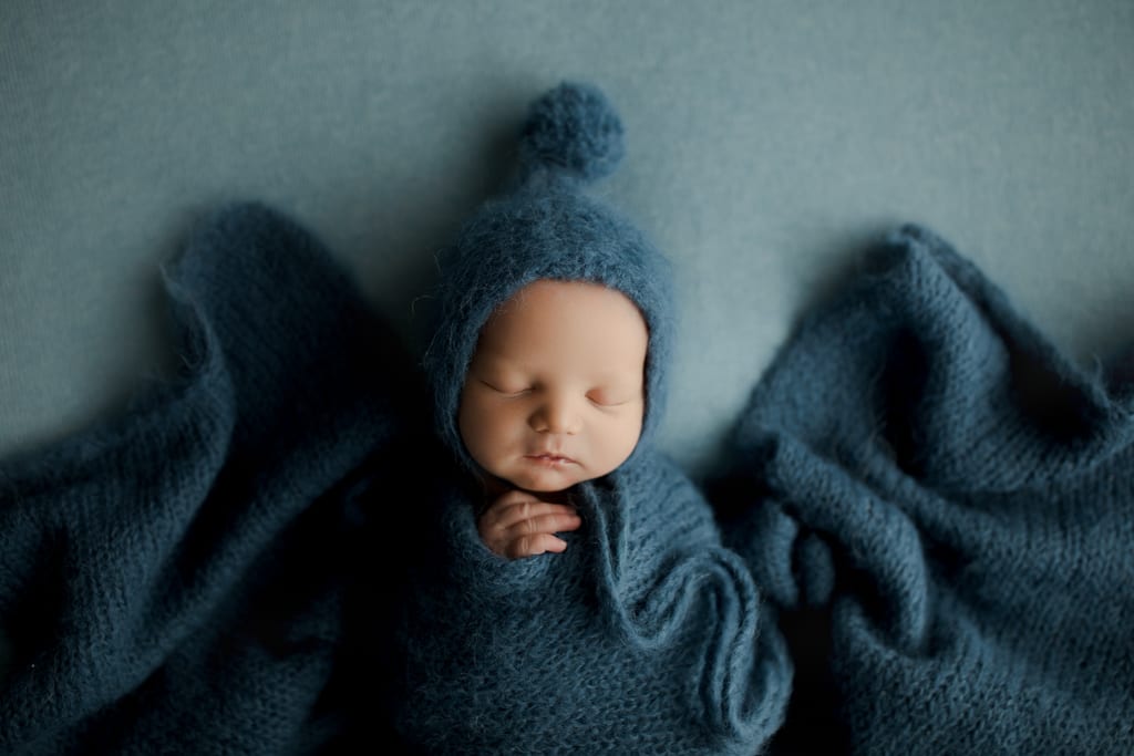 Chicagoland newborn photos, swaddled baby boy with blue hat