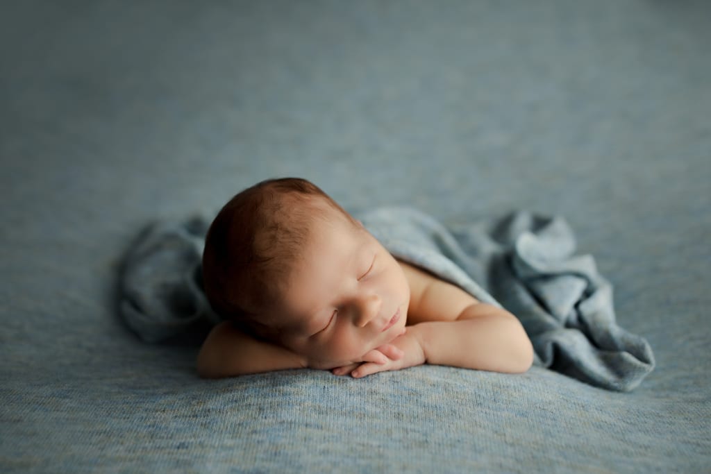Chicago newborn photographer, baby asleep on blue beanbag