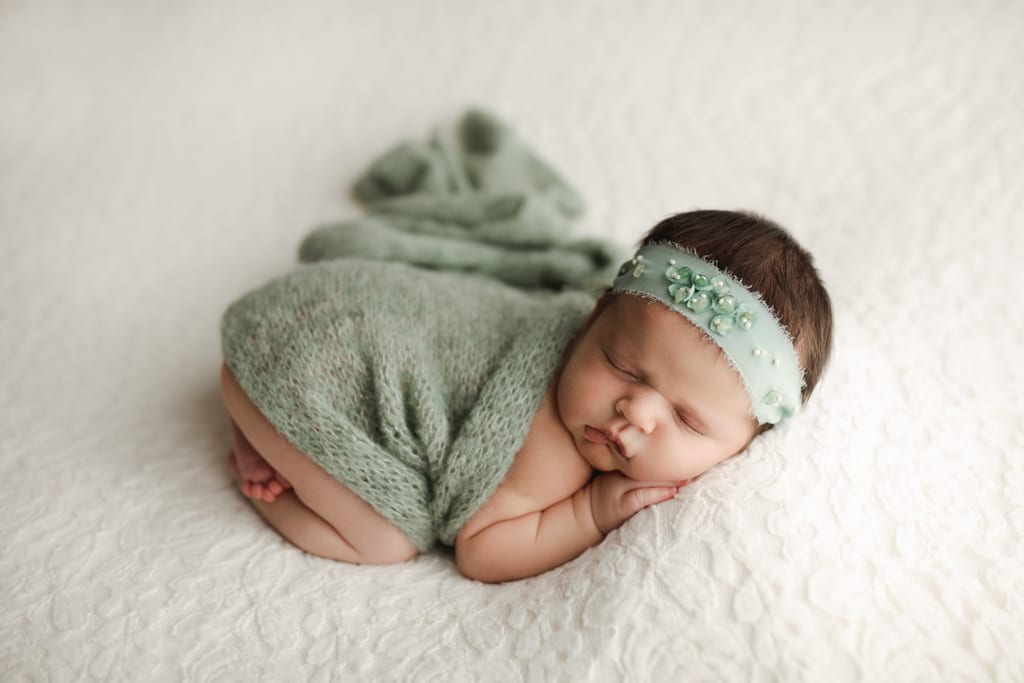 baby girl newborn photos, newborn asleep with green wrap and headband