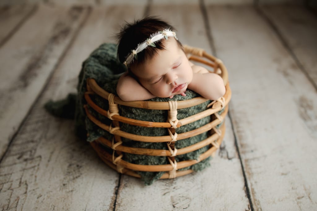 baby girl asleep in wicker basket, best newborn photos near Palatine, IL