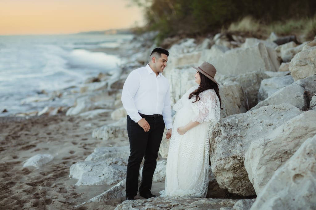 best chicago maternity photographer, husband and wife holding hands on beach