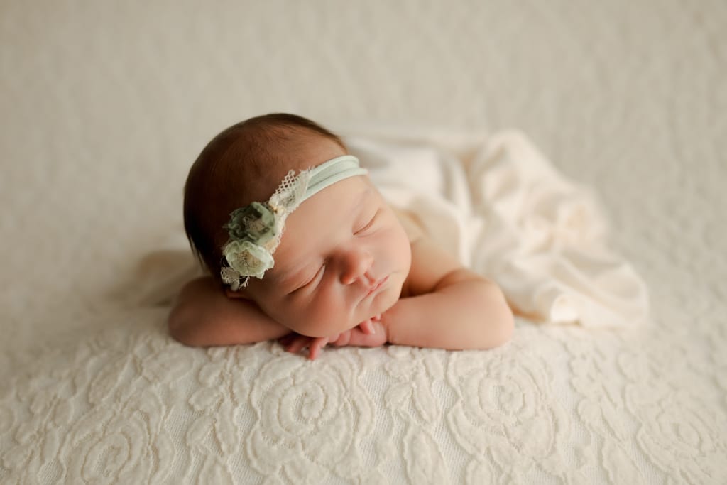 Chicago baby photography, newborn girl asleep on white textured beanbag