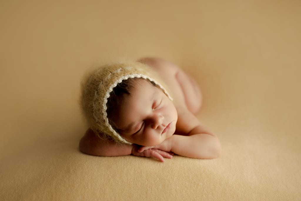 newborn photos Chicago, infant asleep with yellow cap