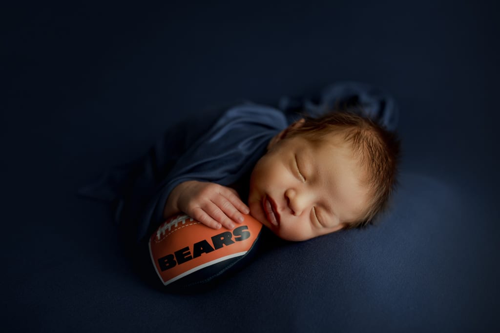 baby boy asleep with Chicago Bears football