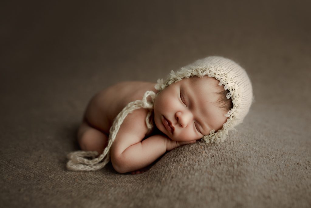 Illinois newborn photographer, sleeping baby wearing white lace-trimmed cap