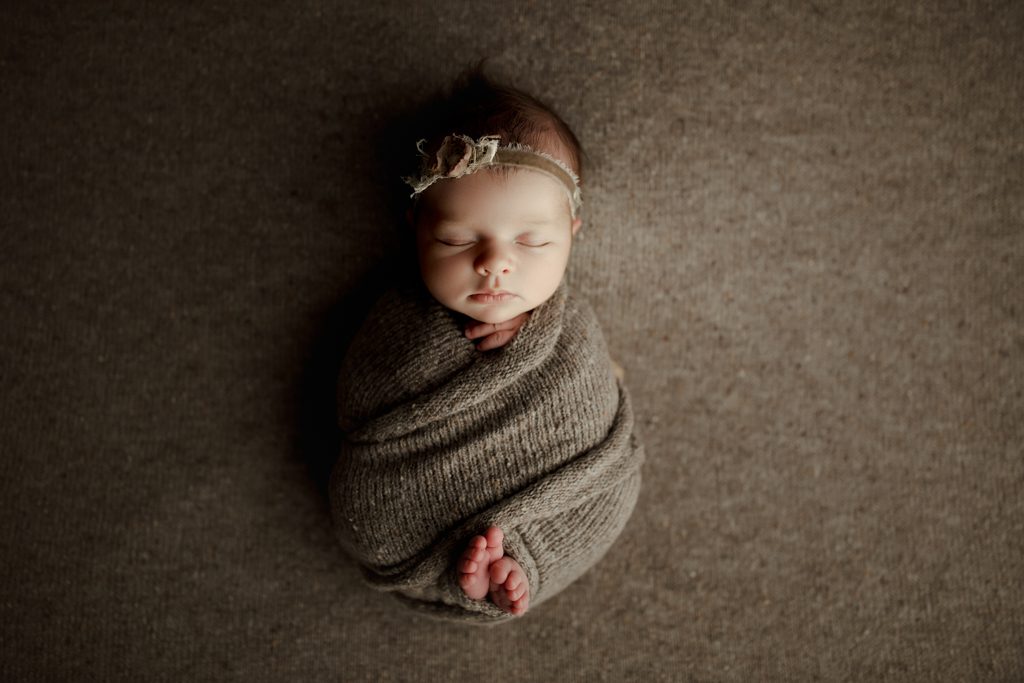 Chicago baby pictures, infant girl in brown swaddle with toes peeking out