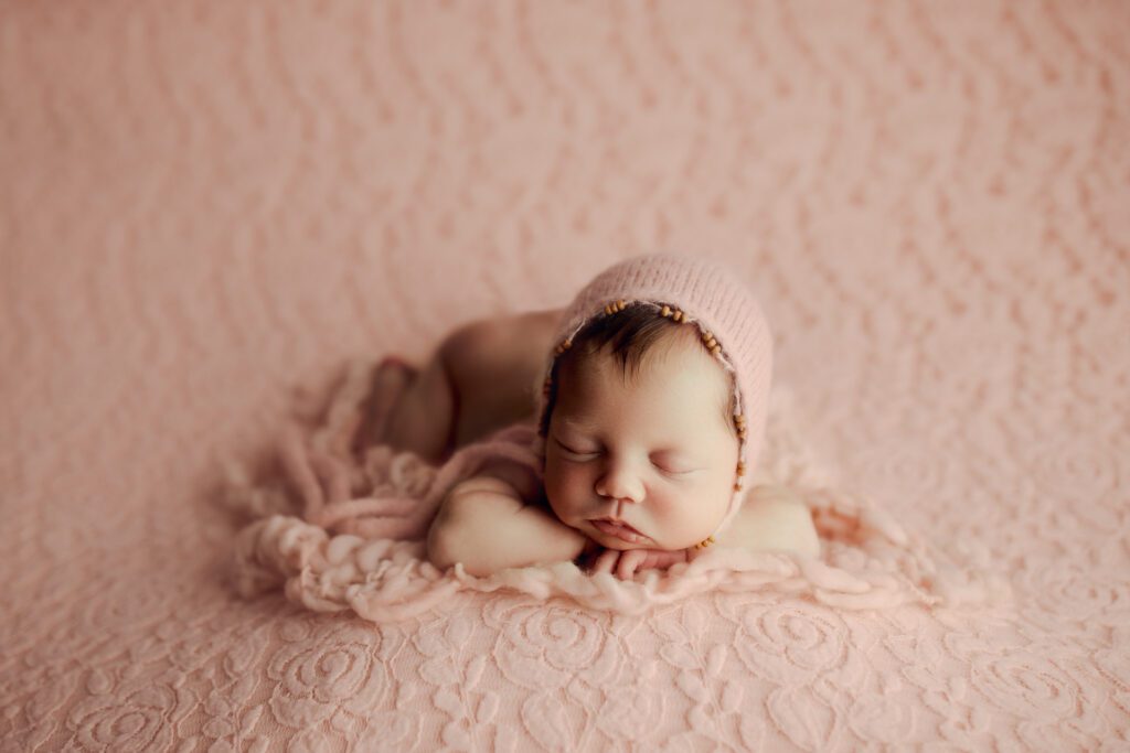 baby girl in pink hat by North Shore Chicago newborn photographer Agata Brannon