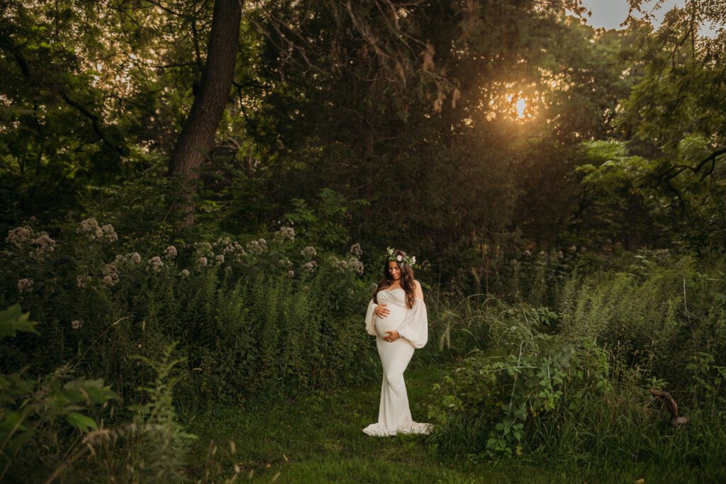 Woman in white maternity gown and floral crown