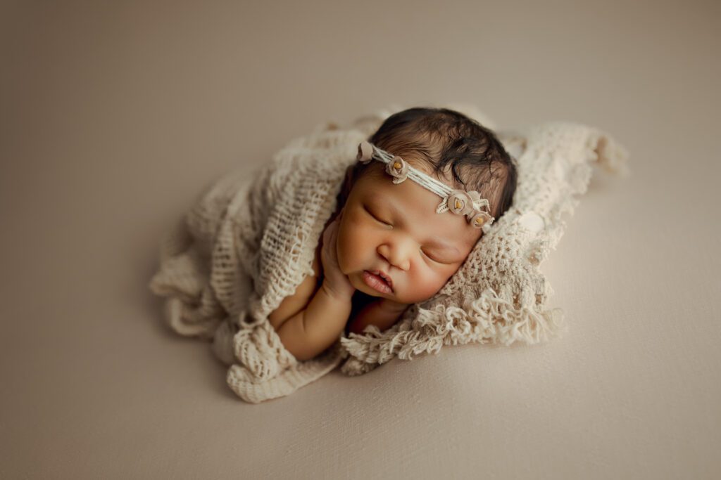 Newborn African American girl asleep in Chicago photo studio