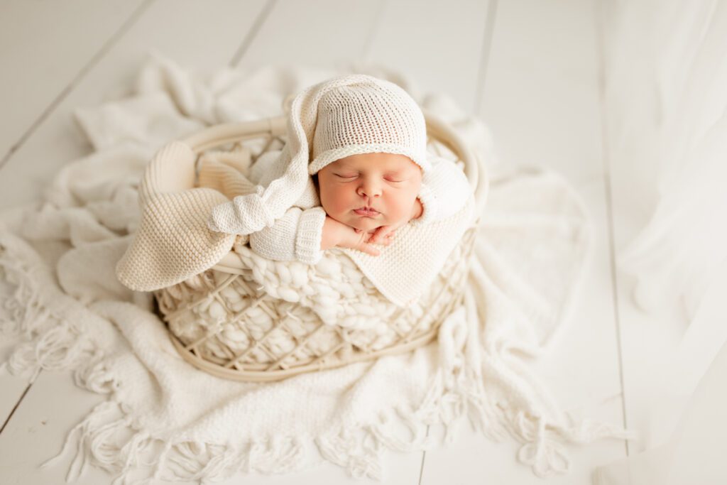 Newborn boy in white basket