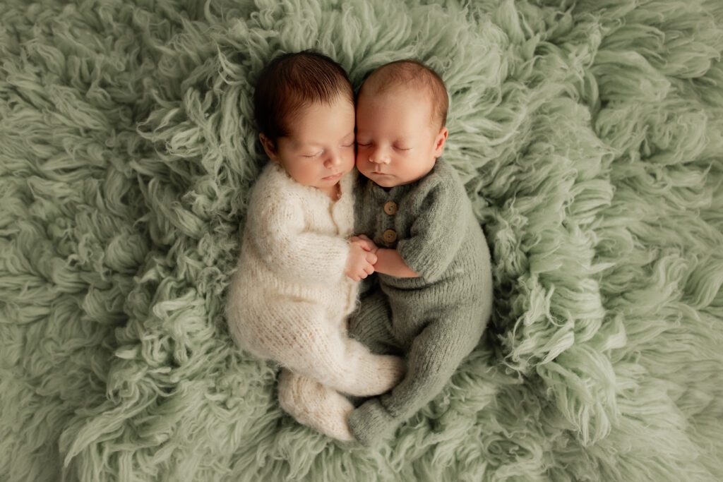 Chicago twin boys babies holding hands in their sleep