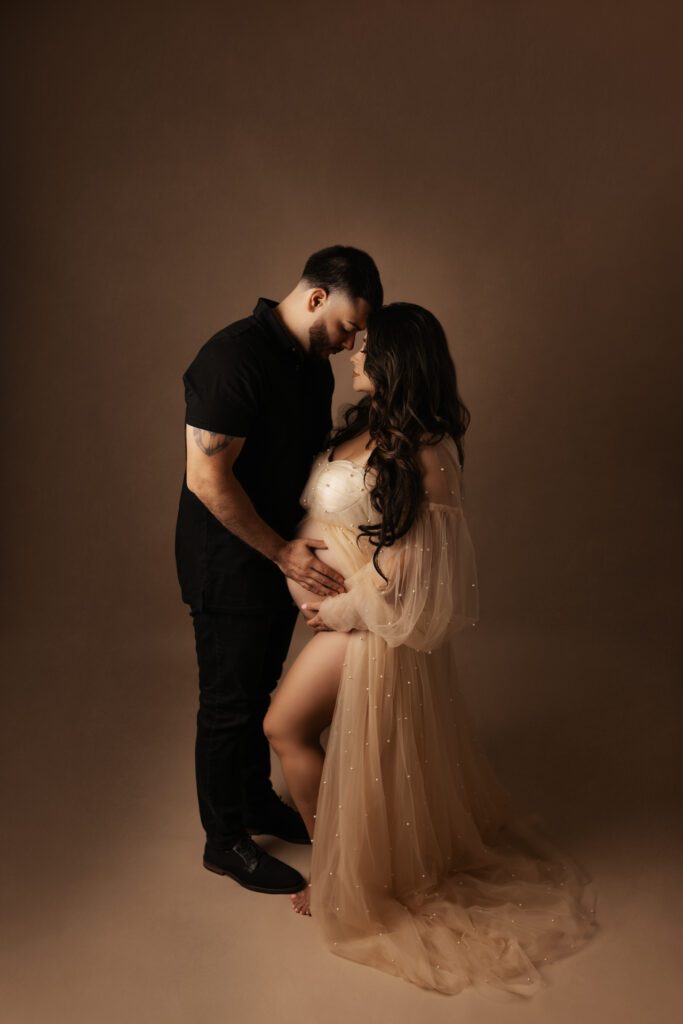 Couple touching foreheads for Chicago studio maternity photos