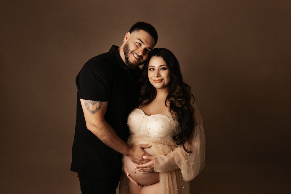 Pregnant couple posing for Chicago studio maternity photos