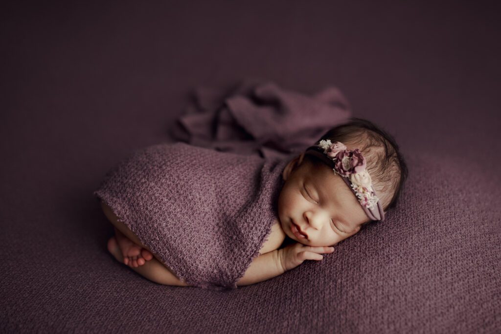 Infant in purple blanket