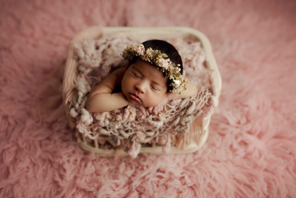 Newborn girl wearing flower crown for newborn photography session in Chicago