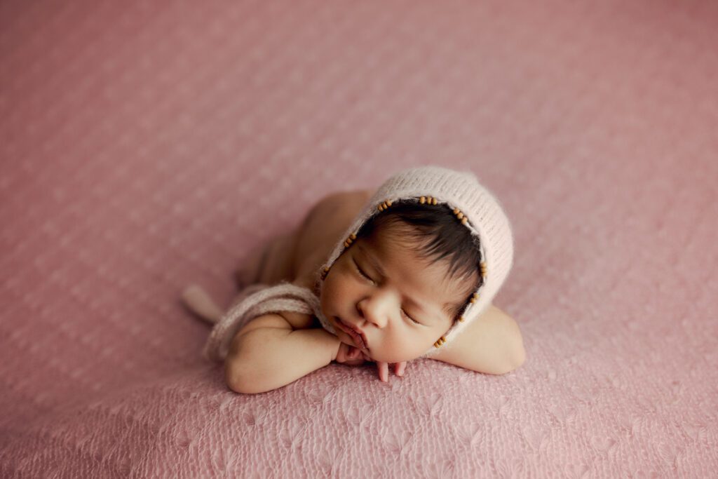Sleeping girl in pink crochet cap