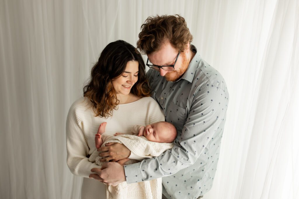 Mom and Dad holding newborn son in Long Grove Illinois photo studio