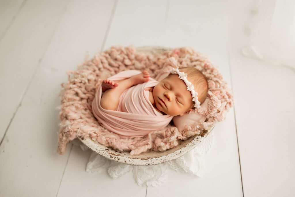 Swaddled baby girl in soft pink