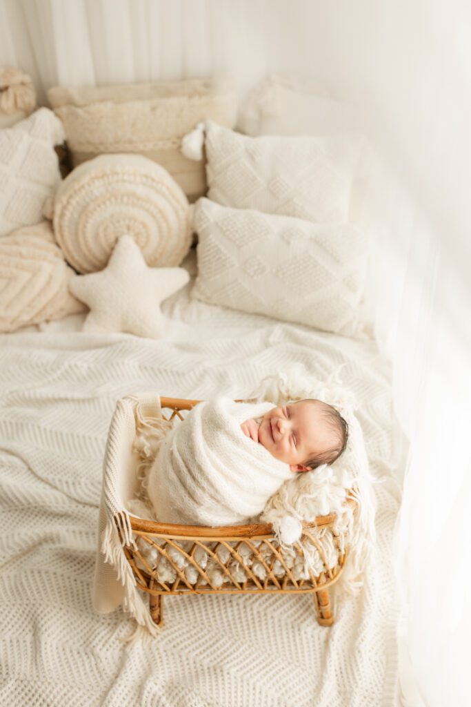 Infant boy smiling in crib