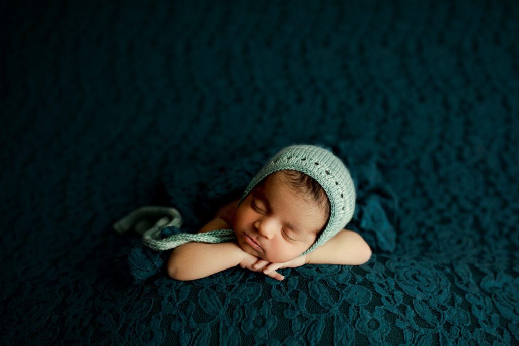 Baby girl asleep with head on hands during Chicagoland newborn photoshoot