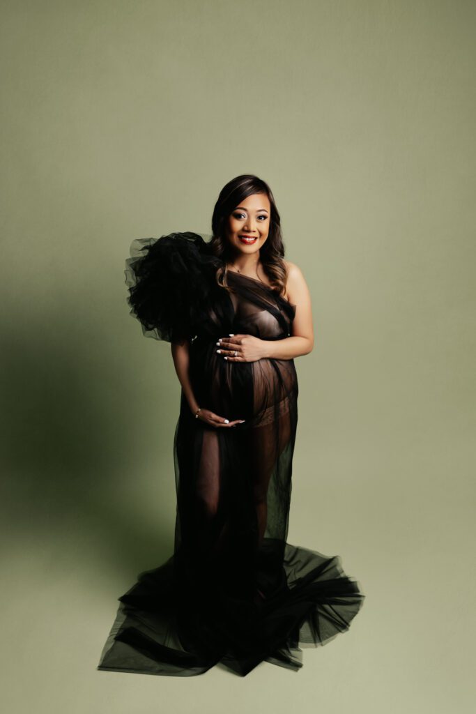 Woman in elegant black maternity gown