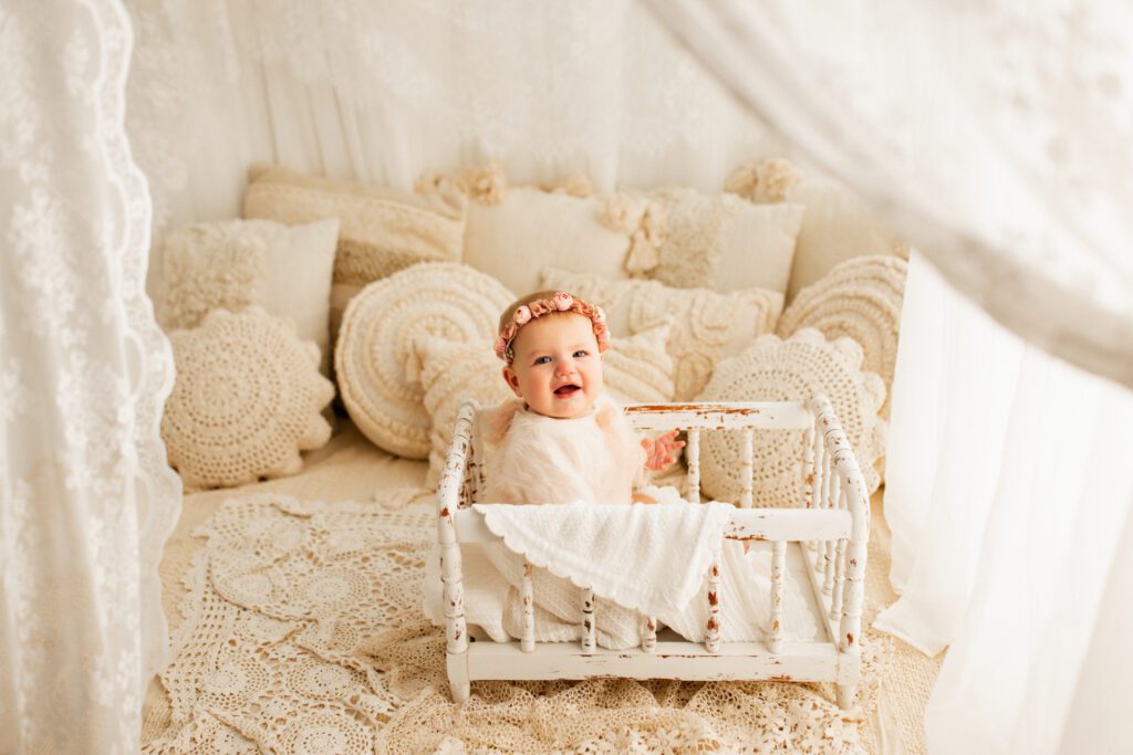 Nursery setup with distressed crib, textured pillows, blanket, and curtains in Chicago studio