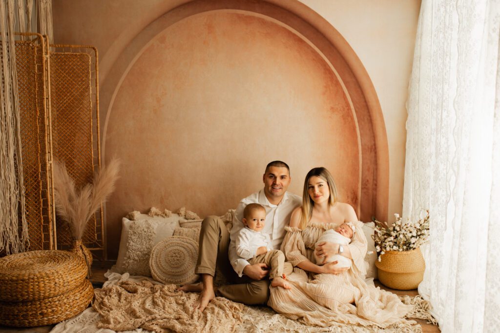 Young family seated in a comfortable, cushioned nook near a window
