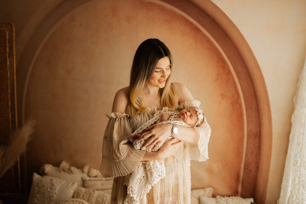 New mama holds her baby in her arms during a Chicago newborn photoshoot