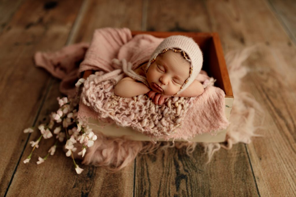 Baby girl dreaming with her chin on her hands in Chicago portrait studio