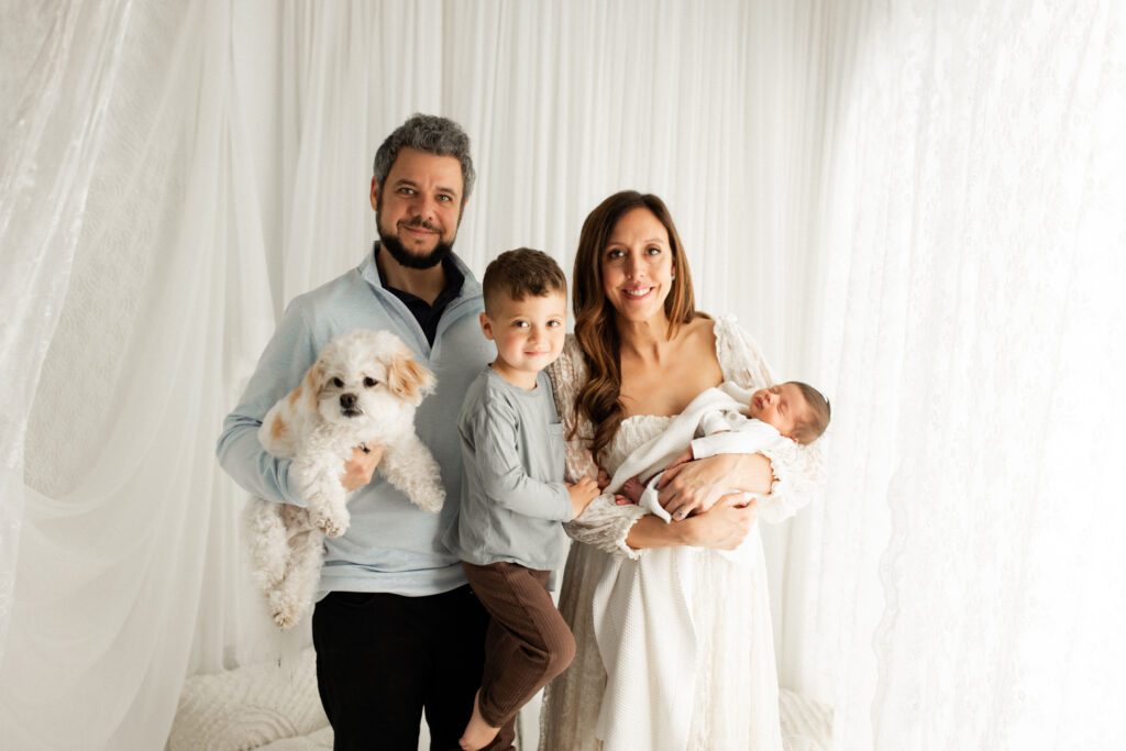 Family poses with their newborn during a Winnetka newborn photoshoot in studio